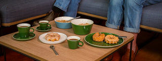 Roman Range on a table of bowls, cups, donuts and cereal.