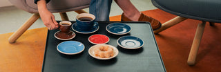 Acme saucers on a table with one cup of coffee
